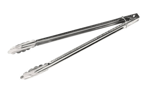 Stainless steel kitchen tongs Stainless steel kitchen tongs (with clipping path) isolated on white background serving tongs stock pictures, royalty-free photos & images