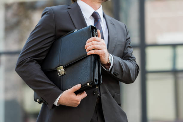 istock cropped view of man holding leather briefcase outside 1192902935