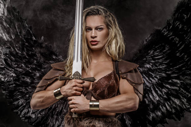 istock Sword wielding viking warrior young blond female in studio shot 1192902980