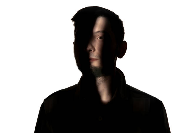 istock Dramatic portrait of a man in the dark on white studio background. 1192903750