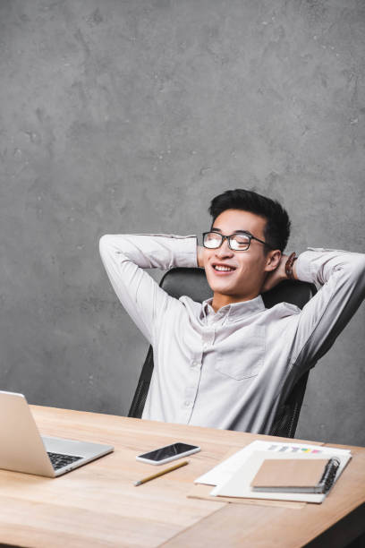 istock smiling asian seo manager sitting at table with crossed arms 1192903825