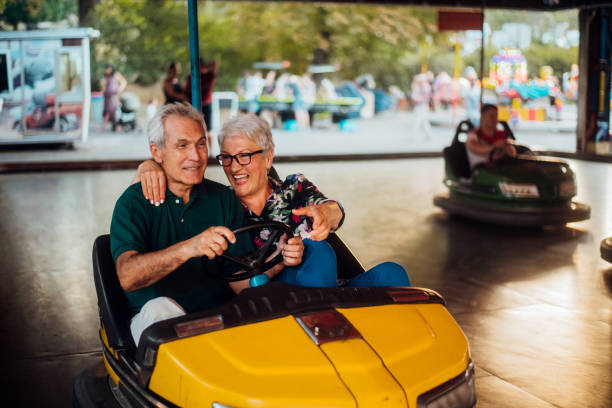 istock Senior couple having fun in a bumper car 1192903854