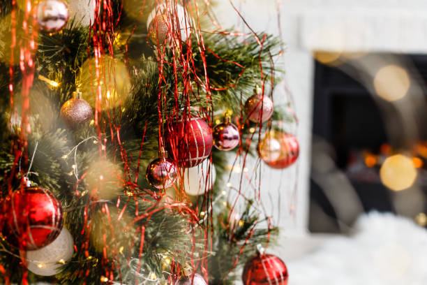 istock Christmas tree near fireplace in room 1192905166