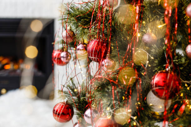 istock Christmas tree near fireplace in room 1192905676