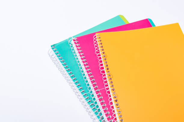 istock high angle view of colorful notebooks isolated on white 1192906181