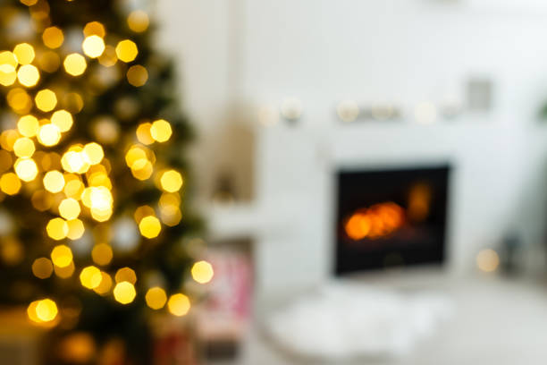 istock Christmas scene with tree gifts and fire in background 1192906910