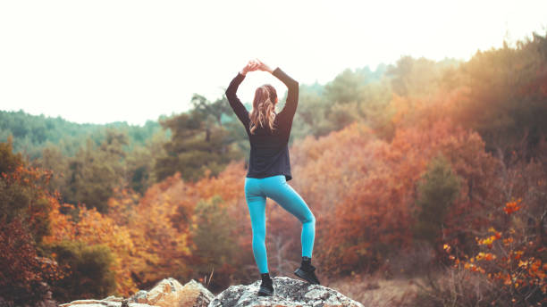 Young athletic woman doing stretching exercises in nature