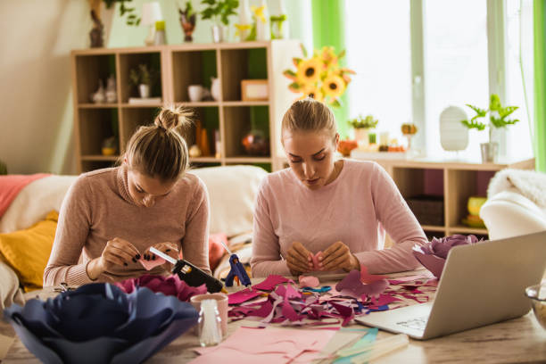 istock Girlfriends concentrating while making decorative flowers out of paper 1192907261