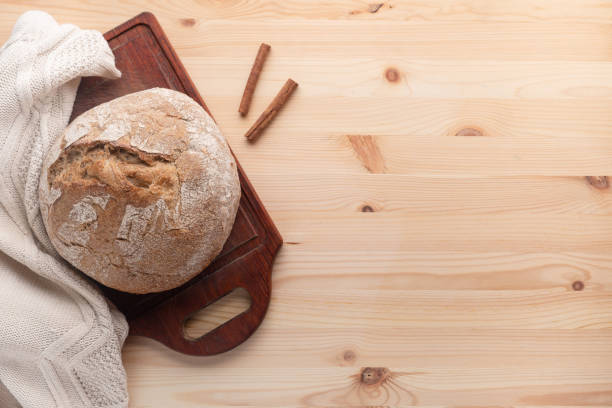 Hot bread on a table made of wood.