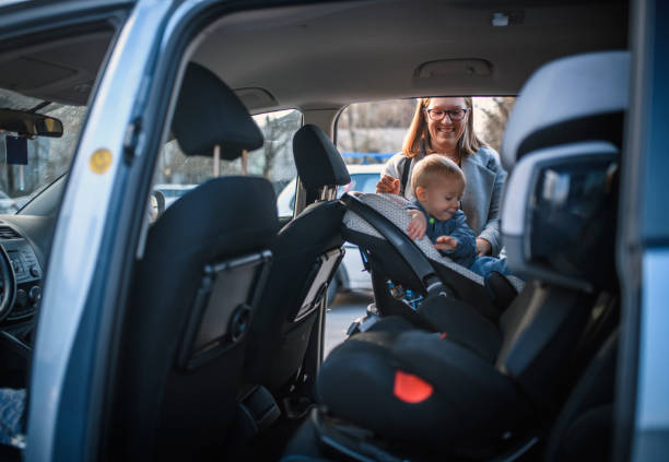 istock Mother Putting her Child to the Car 1192907433