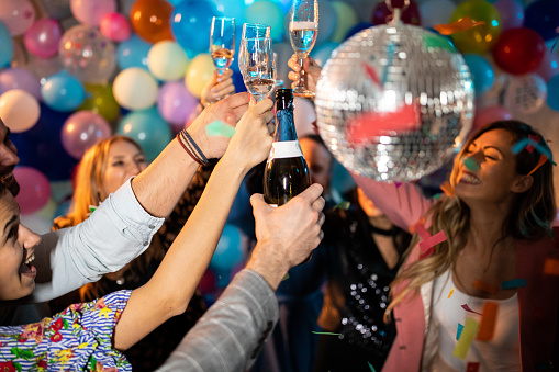 Friends toasting with champagne for their long friendship during party