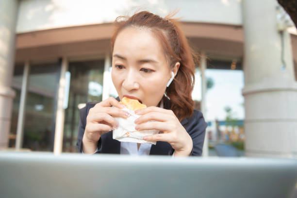 istock Busy young woman using smartphone while working on digital tablet in an outdoor cafe 1192907895