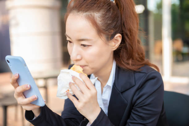 istock Busy young woman using smartphone while working on digital tablet in an outdoor cafe 1192907964