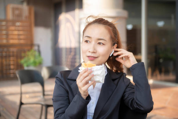 istock Busy young woman using smartphone while working on digital tablet in an outdoor cafe 1192908734