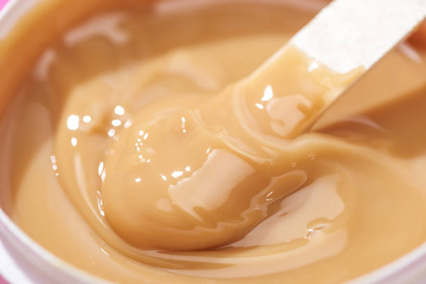 istock close up view of depilation wax in container with stick 1192908760