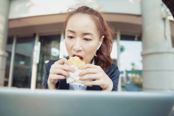 istock Busy young woman using smartphone while working on digital tablet in an outdoor cafe 1192908766