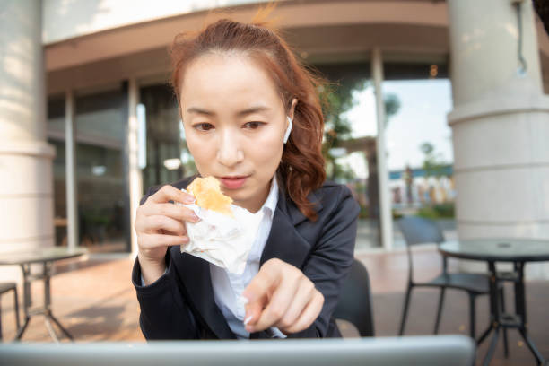 istock Busy young woman using smartphone while working on digital tablet in an outdoor cafe 1192908839