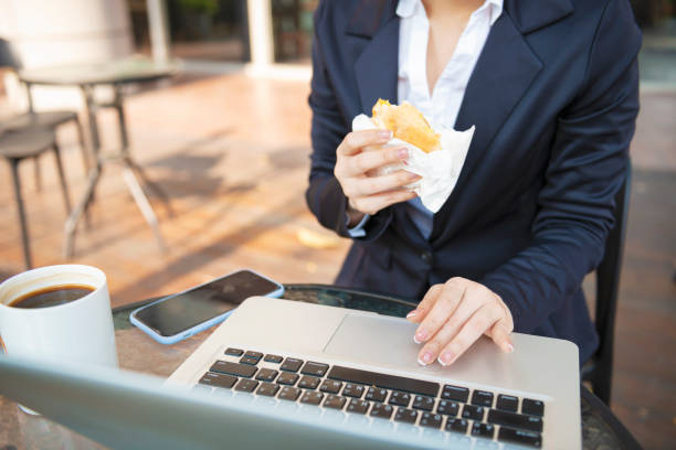 istock Busy young woman using smartphone while working on digital tablet in an outdoor cafe 1192908844
