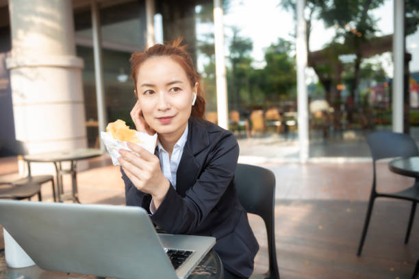 istock Busy young woman using smartphone while working on digital tablet in an outdoor cafe 1192908859