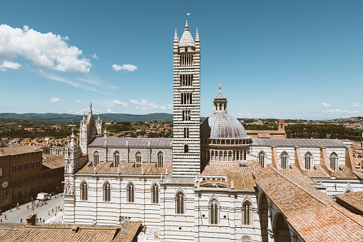 Siena, Italy - June 28, 2018: Panoramic view of exterior of Siena Cathedral (Duomo di Siena) is a medieval church in Siena, dedicated from its earliest days as a Roman Catholic Marian church