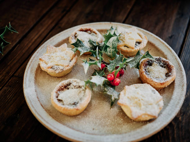 istock Plate of small mince pies with holly dusted with icing sugar. 1192912613
