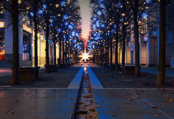 low angle view on illuminated Christmas decoration in Berlin  street at blue hour