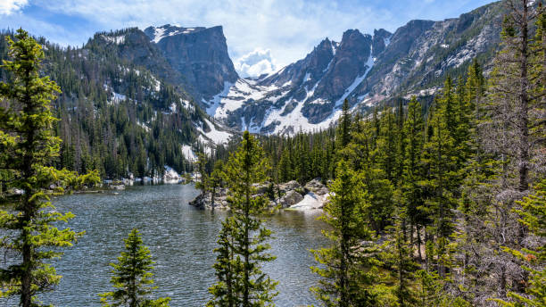 istock Spring Mountains - A Spring panoramic view of Hallett Peak and Flattop Mountain towering at shore of Dream Lake, Rocky Mountain National Park, Colorado, USA. 1192913789