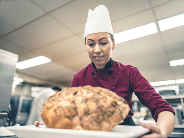istock Female Chef working in industrial kitchen 1192913823
