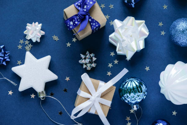 istock Christmas background with decorations and gift boxes on dark blue background 1192913948