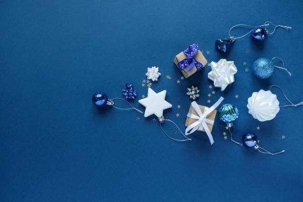 istock Christmas background with decorations and gift boxes on dark blue background 1192913951