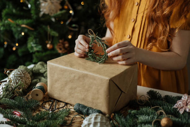istock Children's hands decorate the gift in rustic style 1192913968