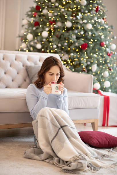 istock Pretty young woman having coffee and looking sad 1192914125
