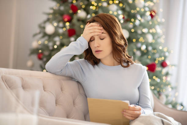 istock Young woman in grey shirt holding an envelope feeling upset 1192914175
