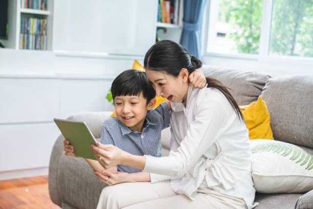 istock Family taking a selfie photo while sitting on sofa at home. 1192915132