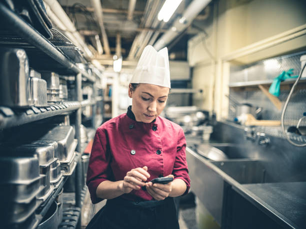 istock Female Chef with mobile phone 1192915231