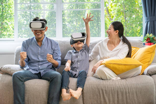 istock Father, mother and sons playing video games. 1192915540