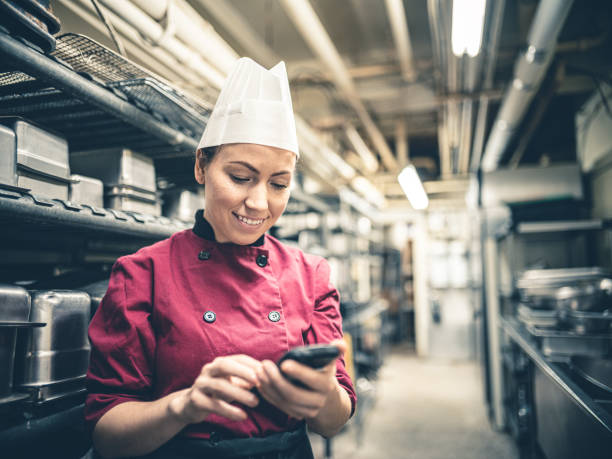 istock Female Chef with mobile phone 1192915611