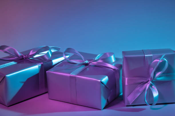 istock Gift boxes illuminated with colorful lights. This file is cleaned and retouched. 1192915620