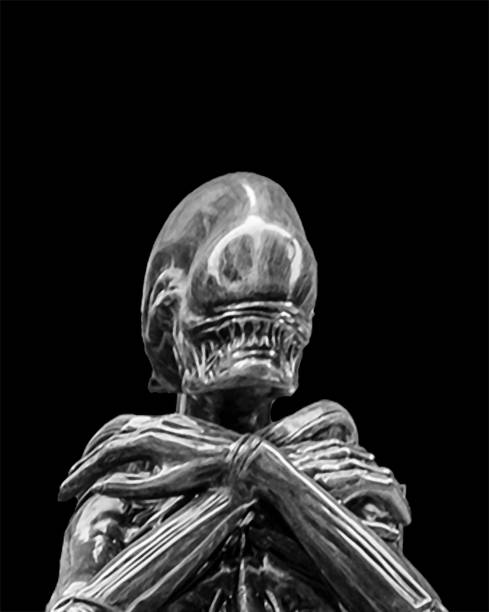 Scary or science fiction motif background depicting an alien monster with crossed arms over black background