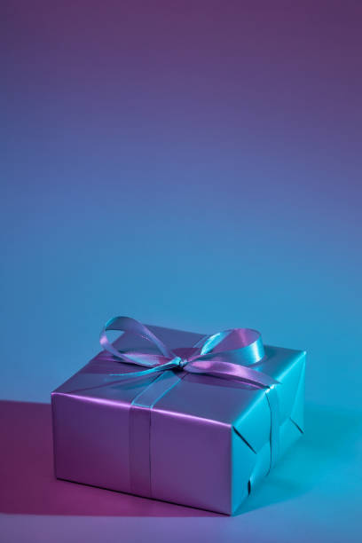 istock Gift box illuminated with colorful lights 1192915858
