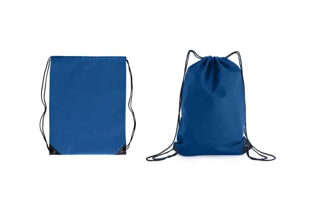 Photo of Set of classic blue drawstring packs template, bag for sport shoes isolated on white.