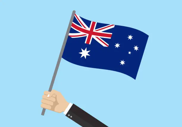 Vector illustration of Australia waving flag. Hand holding Australian flag. National symbol with Southern Cross constellation. Vector illustration.