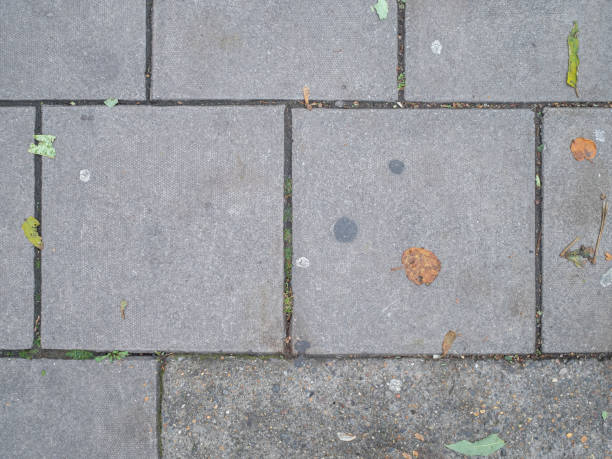 Full frame high angle view of grey concrete paving slabs