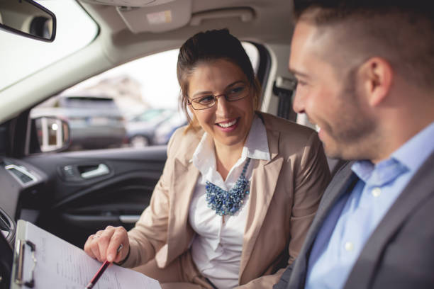 istock Young man buys a car on a car lot 1192922912