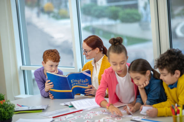 istock Teacher explaining English grammar to primary school pupils 1192924255