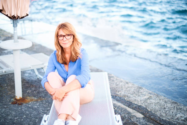 istock Middle aged woman relaxing on the seaside 1192924561