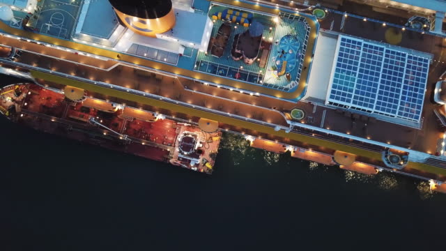Large docked cruise ship at the sea port, top view. Stock. Sunset cruise liner with everything for the luxury vacation