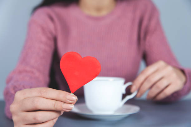 istock woman hand coffee and red heart 1192926374