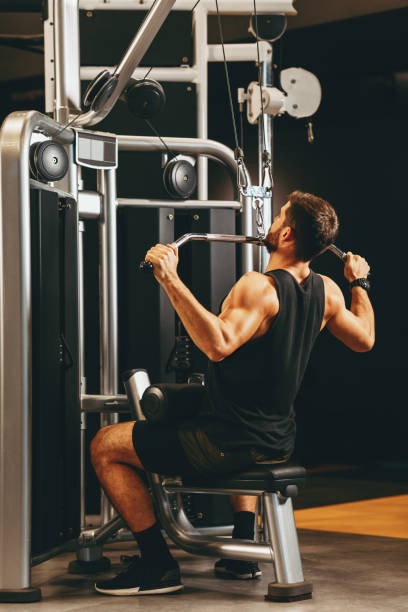 istock Young muscular man pulling up on horizontal bar in a gym 1192927231
