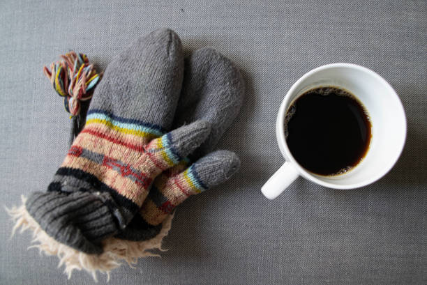 istock Coffee mug and cozy winter gloves 1192927504